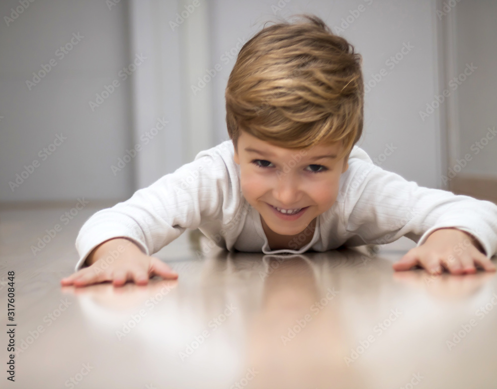 Happy boy having fun while crawling on the floor. Happy boy having fun while crawling on the floor.