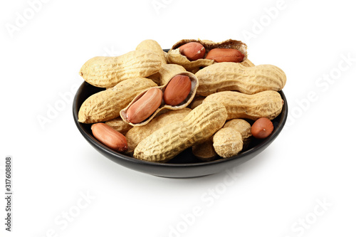 Dried peanuts in a black plate isolated on white background. Food