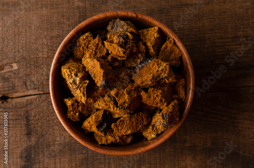 Bowl with Chaga mushroom. medicinal drink with pieces of chaga photo