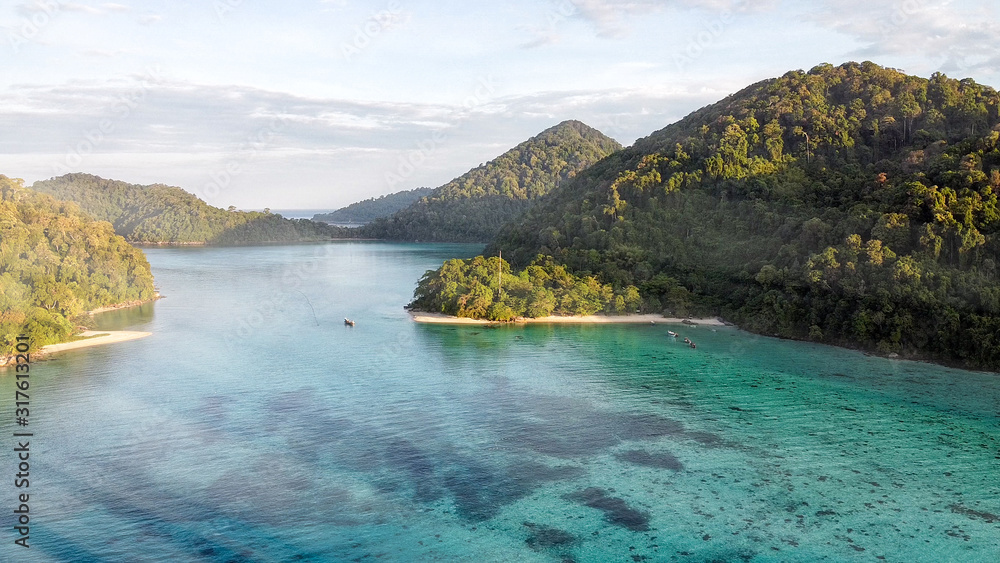 Fototapeta premium Mountains and coral reef on a wonderful seascape scenario, aerial view