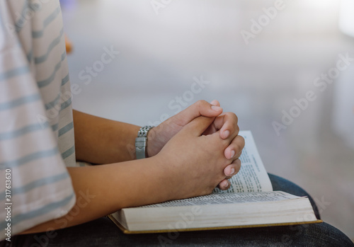 Beautiful woman hands praying to god blessing on bible to wishing have a better life.
