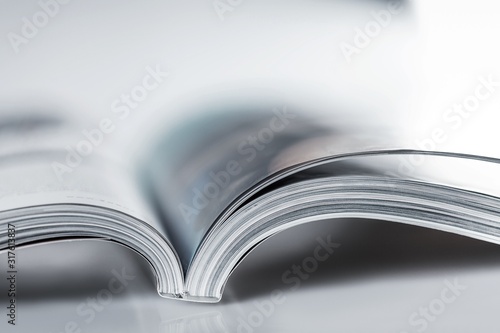 Pile of Open magazines, blue toned image photo