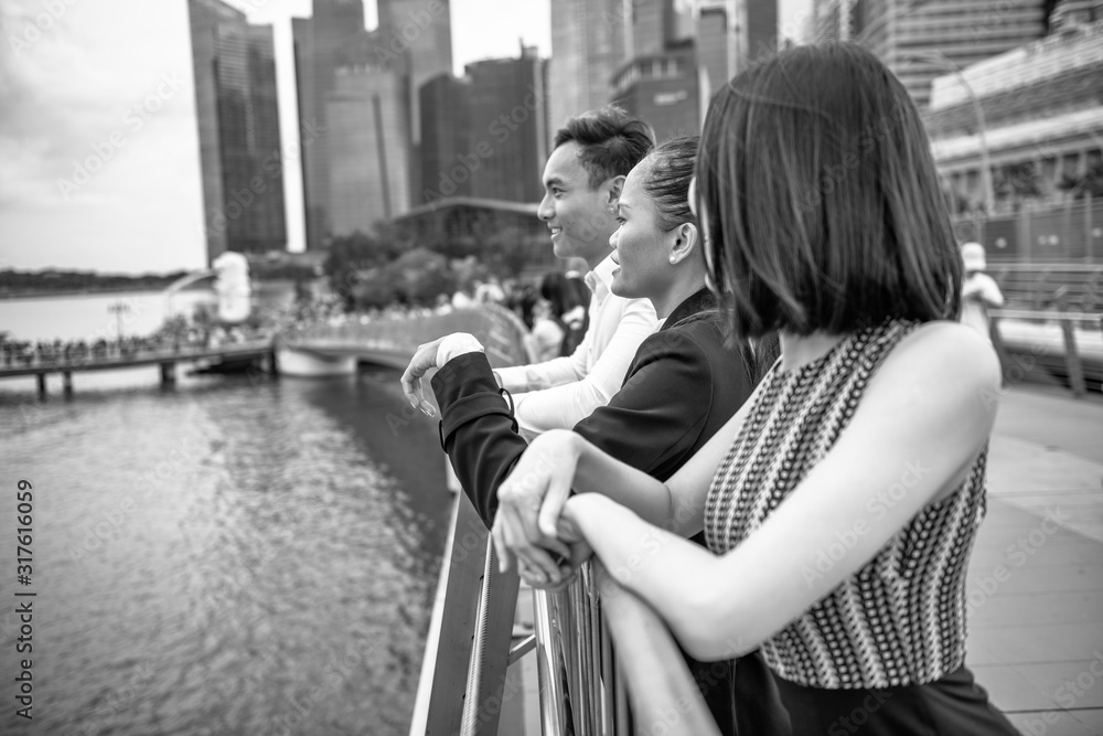 Group of Three Asian Friends enjoy the visit of a big metropolitan city
