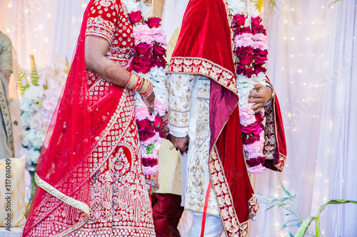 Indian hindu wedding and pre wedding ritual pooja items and hands close up