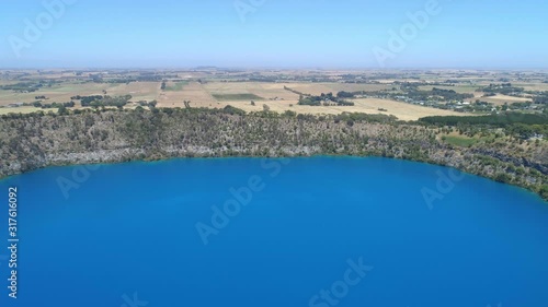Aerial descend over volcanic Blue Lake lookout in Mount Gambier, South Australia photo