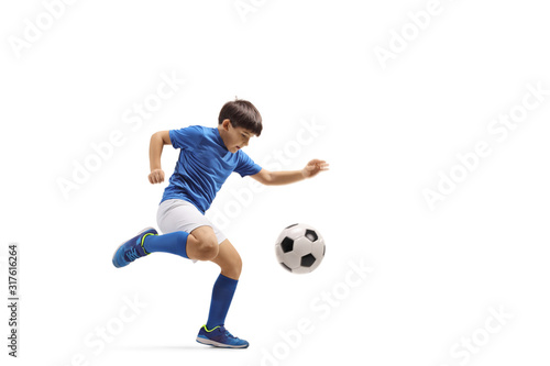 Boy kicking a soccer ball © Ljupco Smokovski