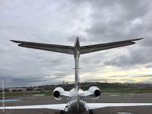 Private business jet parked in the airport courtyard at dawn