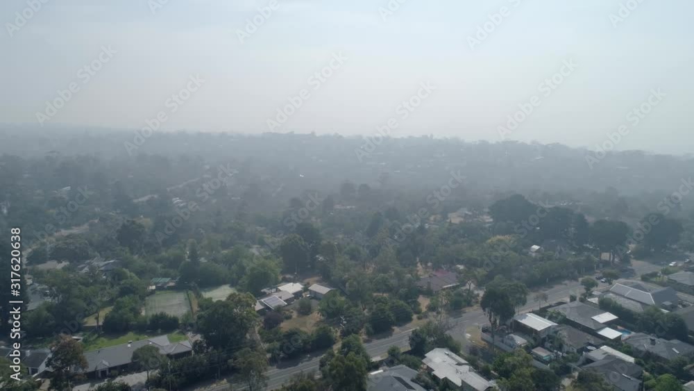 Slow aerial descend over Melbourne suburbs covered in smoke haze from bush fires Slow aerial descend over Melbourne suburbs covered in smoke haze from bush fires