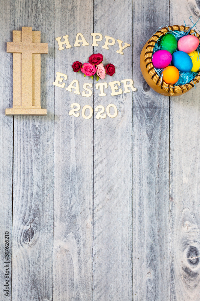 Cross, Easter eggs and happy Easter 2020 on a wood background Cross, Easter eggs and happy Easter 2020 on a wood background
