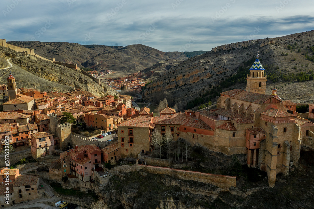 Aerial panorama view of Albarracin in Teruel Spain, with red sandstone terracotta medieval houses, Moorish castle and ancient city walls  voted most beautiful Spanish village