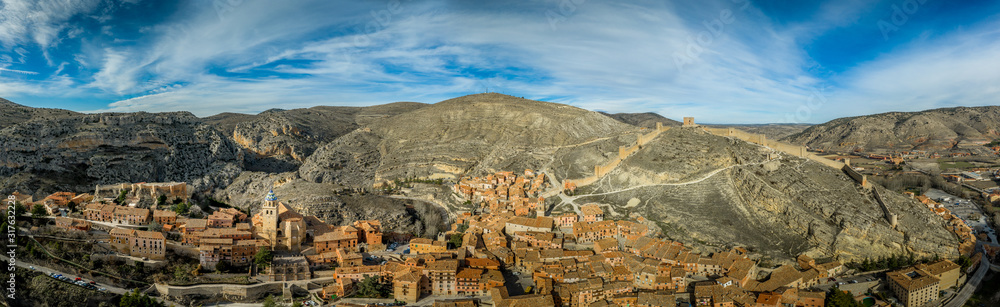 Fototapeta premium Aerial panorama view of Albarracin in Teruel Spain, with red sandstone terracotta medieval houses, Moorish castle and ancient city walls voted most beautiful Spanish village