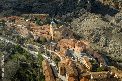 Aerial panorama view of Albarracin in Teruel Spain, with red sandstone terracotta medieval houses, Moorish castle and ancient city walls  voted most beautiful Spanish village © tamas