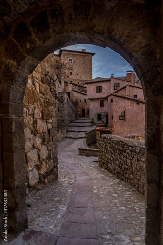 Aerial panorama view of Albarracin in Teruel Spain  with red sandstone terracotta medieval houses  Moorish castle and ancient city walls  voted most beautiful Spanish village