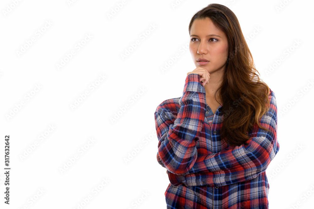 Studio shot of young beautiful woman thinking while looking away Studio shot of young beautiful woman thinking while looking away