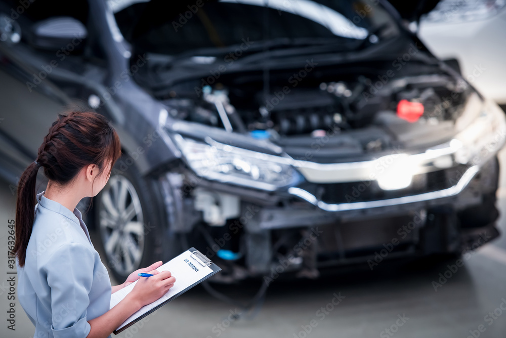 Fototapeta premium Insurance agent staff writes on clipboard while checking the car after being evaluated and proceeded to claim the accident - the car has accident insurance.