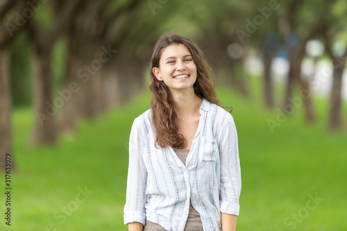 Picture portrait of a beautiful woman smiling in the park