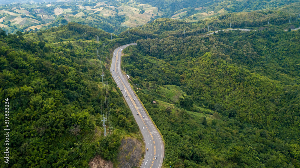 Aerial view of asphalt road on the hill in Phetchabun province, Thailand, Top of view highway road north in Thailand Aerial view of asphalt road on the hill in Phetchabun province, Thailand, Top of view highway road north in Thailand