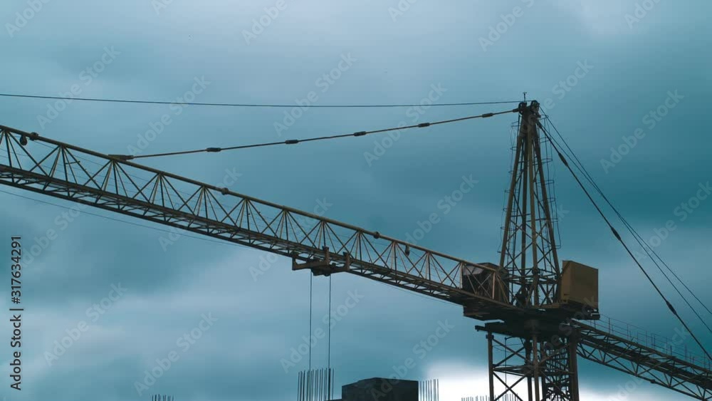 time lapse. Working crane at the construction site. on the background of beautiful cloudy sky time lapse. Working crane at the construction site. on the background of beautiful cloudy sky