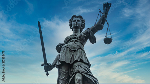 Justice Statue with Sword and Scale in Frankfurt Main isolated on white Background