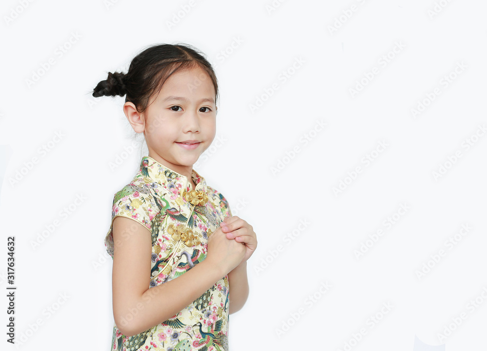 Beautiful Asian little girl wearing cheongsam with smiling and welcome gesture celebrating for happy Chinese New Year isolated on white background with copy space. Beautiful Asian little girl wearing cheongsam with smiling and welcome gesture celebrating for happy Chinese New Year isolated on white background with copy space.