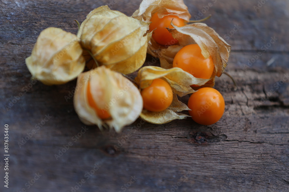 cape gooseberry on wood table cape gooseberry on wood table