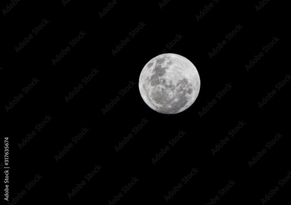 Full moon in great detail with the all black back of the dark night Full moon in great detail with the all black back of the dark night