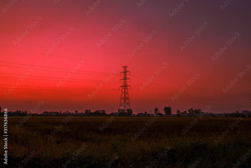 Blurred twilight evening background on rice paddies, with high voltage electricity towers passing through, cool and fresh air while traveling Blurred twilight evening background on rice paddies, with high voltage electricity towers passing through, cool and fresh air while traveling