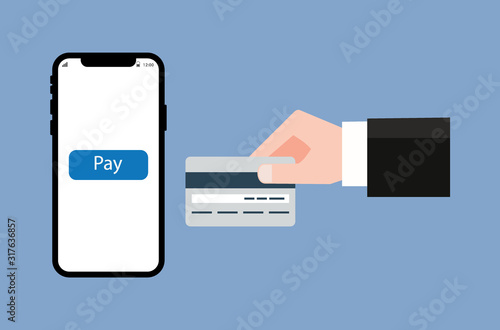 Conducting financial transactions via mobile banking. The hand is holding the credit card between the side of the phone. Pay with credit card.