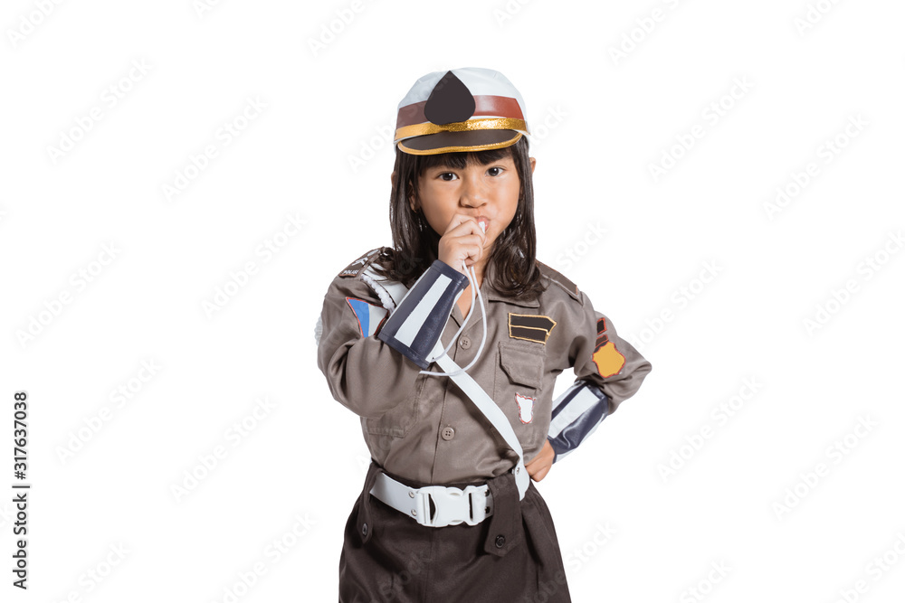 Fototapeta premium Asian little girl wearing a police uniform with a whistle blowing on an isolated background
