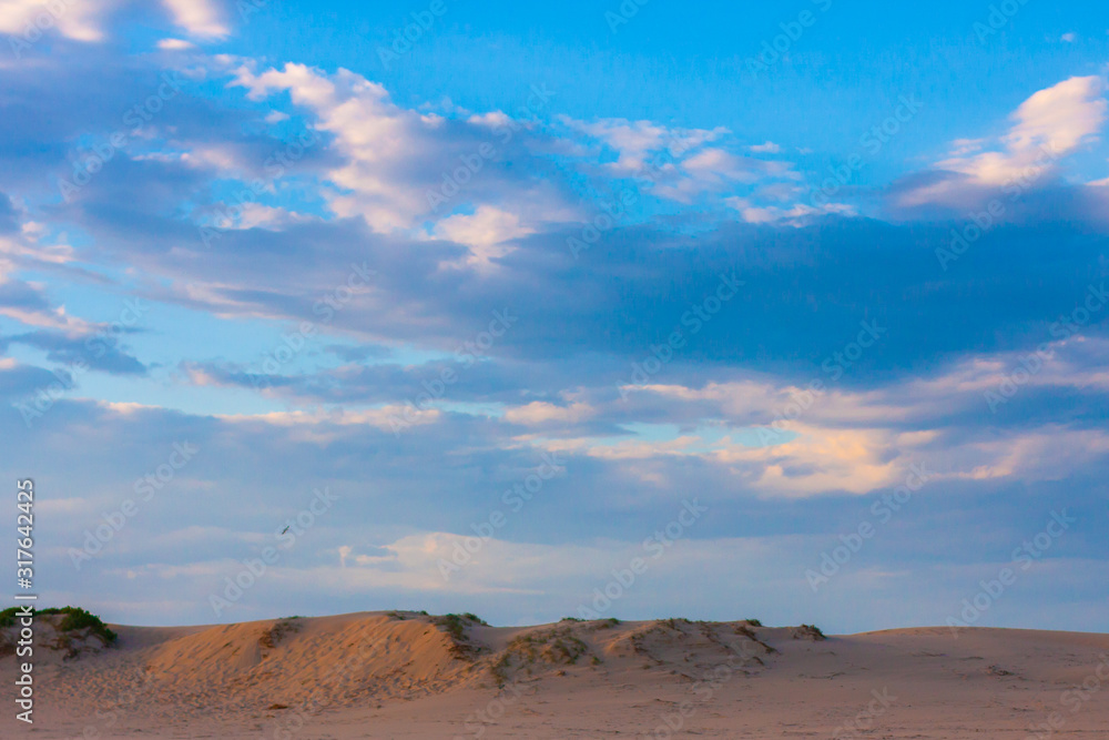 Wide blue cloudy sky over sand dunes. Stockton Sand Dunes near the coast, Worimi Regional Park, Anna Bay, Australia