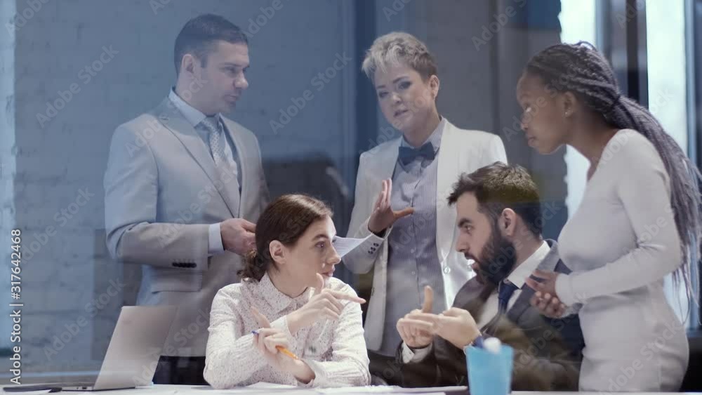 Business meeting, multi-ethnic team of managers in a negotiation room. Hot discussion of the future creative project.