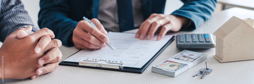 Fototapeta premium Sale representative offer house purchase contract to buy a house or apartment or discussing about loans and interest rates.