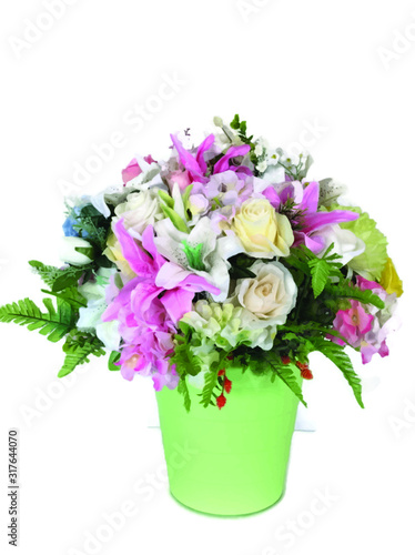 Many colorful bouquet of flowers in a green vase on a white background