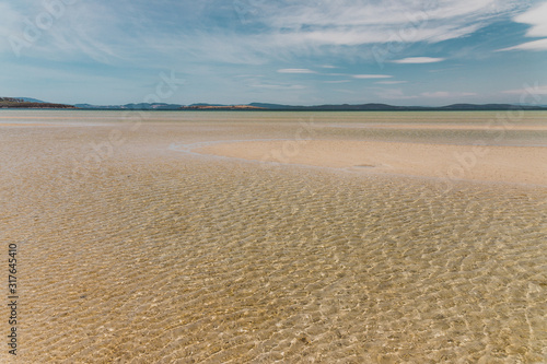 view of Dunalley Beach in Tasmania  Australia with sandbanks and shallow pristine water