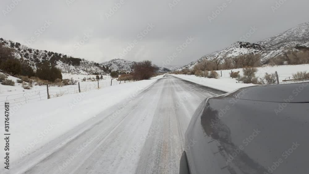 Driving POV mountain valley rural winter snow. Winter storm in rural farming community. Mountain valley seasonal cold weather. Snow and ice on road and landscape. Driving point of view weather. Driving POV mountain valley rural winter snow. Winter storm in rural farming community. Mountain valley seasonal cold weather. Snow and ice on road and landscape. Driving point of view weather.