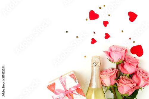 Valentine's day background. Bouquet of pink roses flowers, gift box and champ...