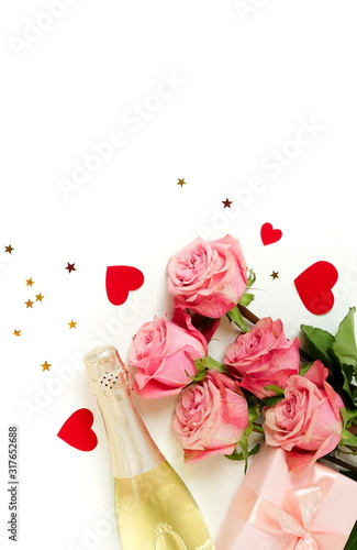 Valentine's day background. Bouquet of pink roses flowers, gift box and champ...