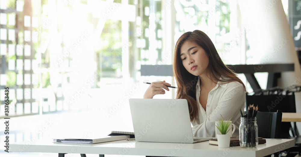 Concept business woman working and people happy businesswoman or creative female office worker with computers writing to notebook with documents and laptop. Concept business woman working and people happy businesswoman or creative female office worker with computers writing to notebook with documents and laptop.