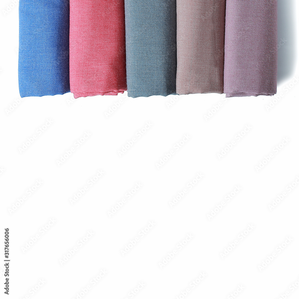 Row of fabric rolls lay and space for copy isolated on white