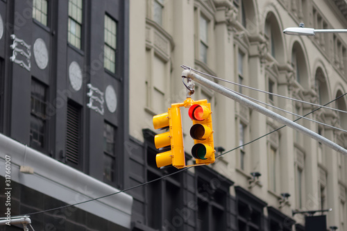 New York City's yellow Traffic Light on background of skyscrapers. Red stop signal. photo