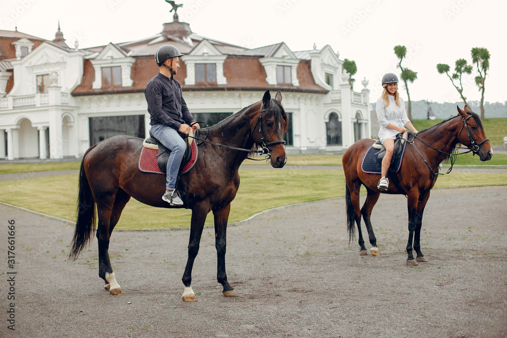 Couple in a summer rainy park. Pair standing with a horse. Girl in a white dress Couple in a summer rainy park. Pair standing with a horse. Girl in a white dress