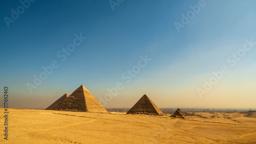 Great Cheops Pyramid and the smaller pyramids with downtown Cairo in the background