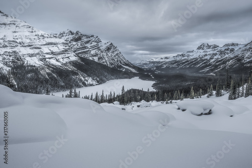 Winter in Peyto Lake in Mistaya Valley against Caldron Peak and Mount Patterson, Bow Summit, Banff National Park, Alberta, Canada photo