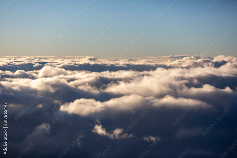 Aerial view of clouds seen from the plane window Aerial view of clouds seen from the plane window