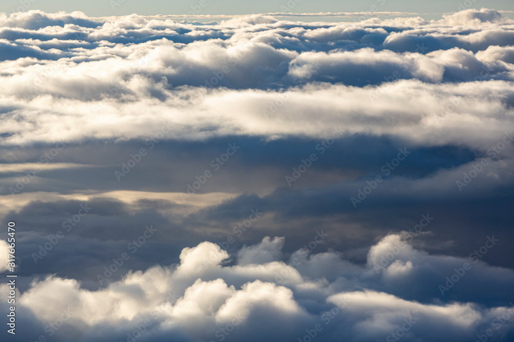 Aerial view of clouds seen from the plane window Aerial view of clouds seen from the plane window