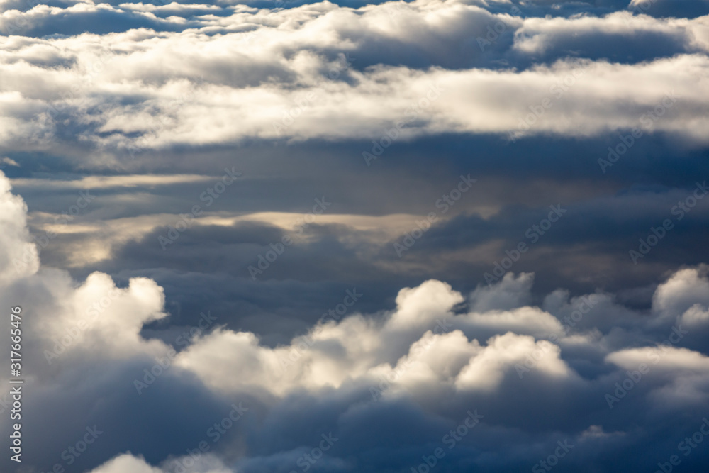 Aerial view of clouds seen from the plane window Aerial view of clouds seen from the plane window
