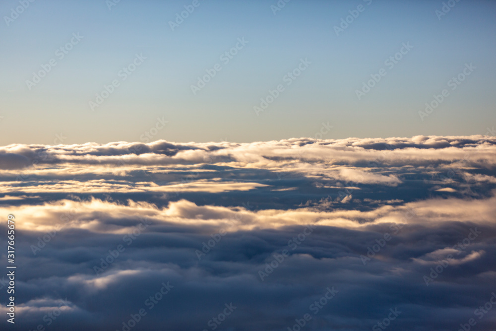 Aerial view of clouds seen from the plane window