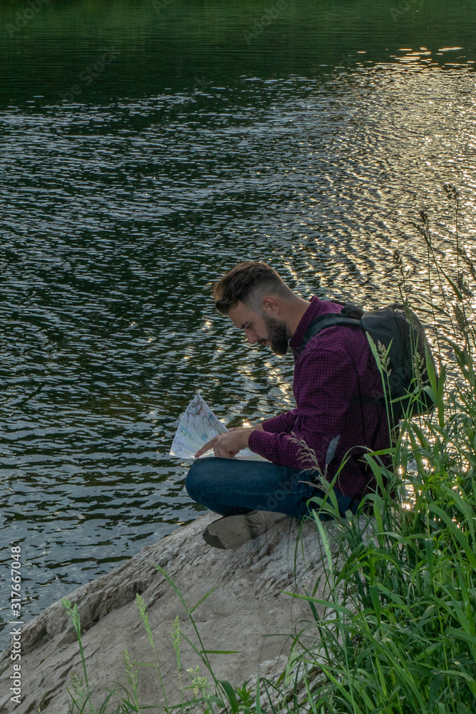 lost man observing map to find the the right way