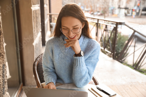 Young woman with laptop in ...