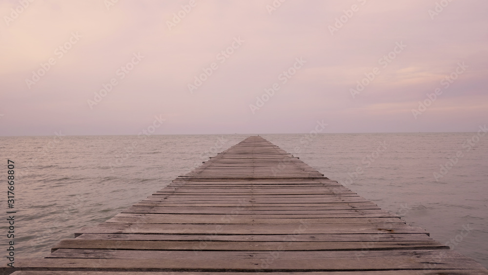 wooden bridge to the sea and Orange sunset sky, summer mood, tranquil relaxing sunlight